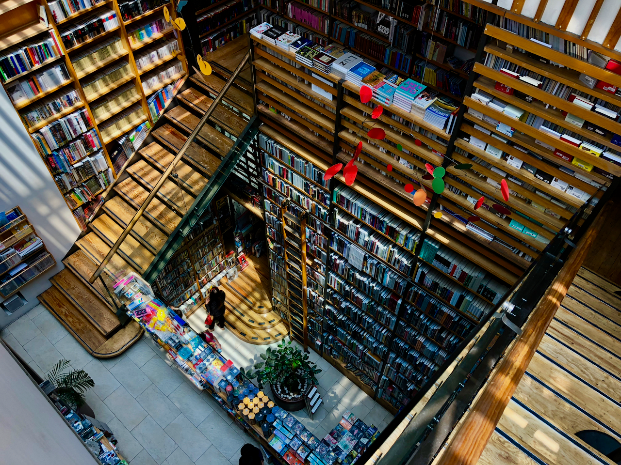 Interior of a multi-level library with wooden bookshelves